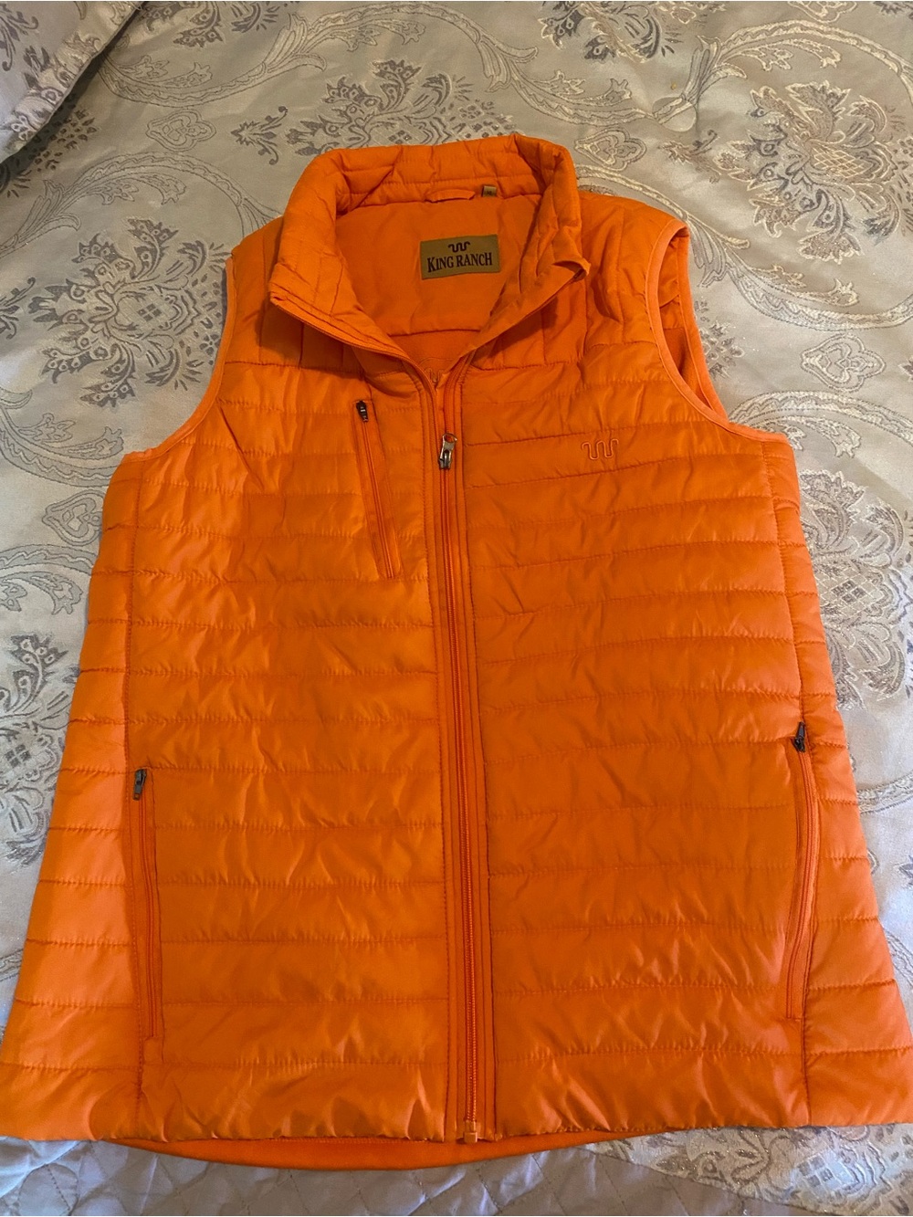 Women’s King Ranch lightweight puffer vest in vibrant orange.XL